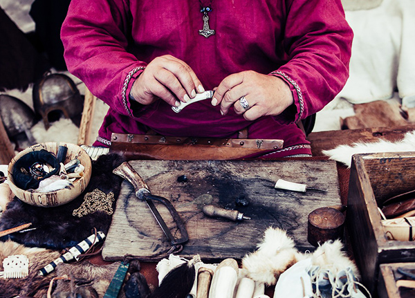 Hands creating craft items out of bone and antlers