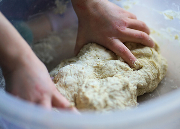 Hands kneeding dough