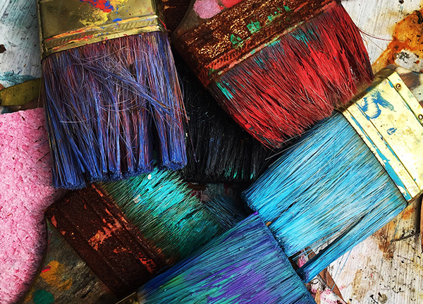 Paintbrushes covered with colorful paint