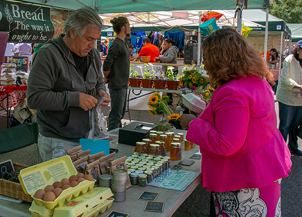 Woman buys goods from a farmer's market