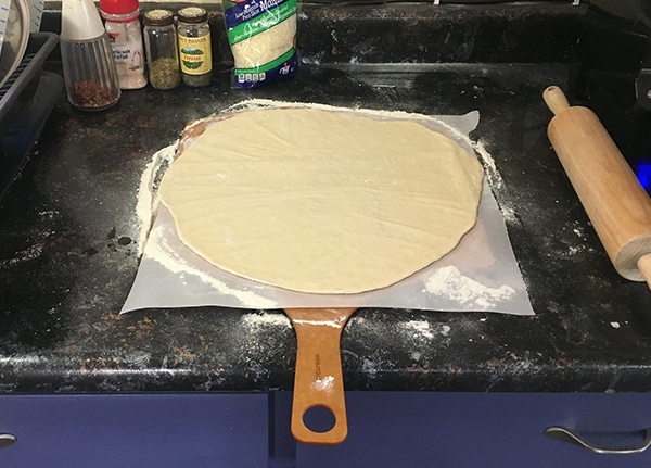 Pizza dough rolled out