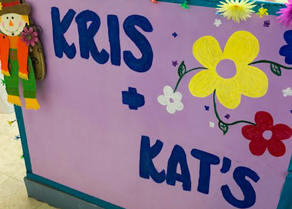 Painted sign that says Kris and Kat's