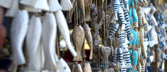 Carved wooden fish hanging from strings