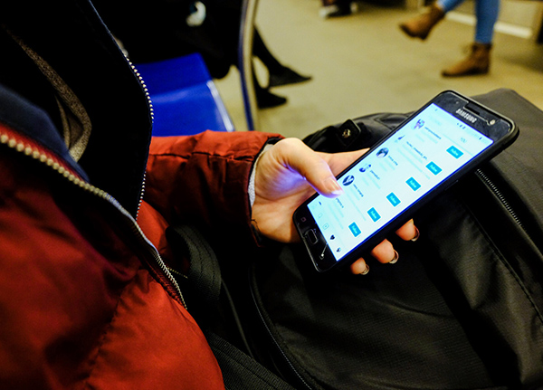 Hand scrolling through social media platform on smartphone