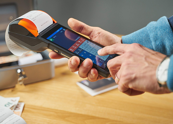 Smartphone with attached device that is printing a receipt