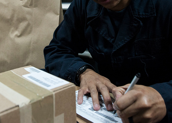 Person filling out mailing information for a package