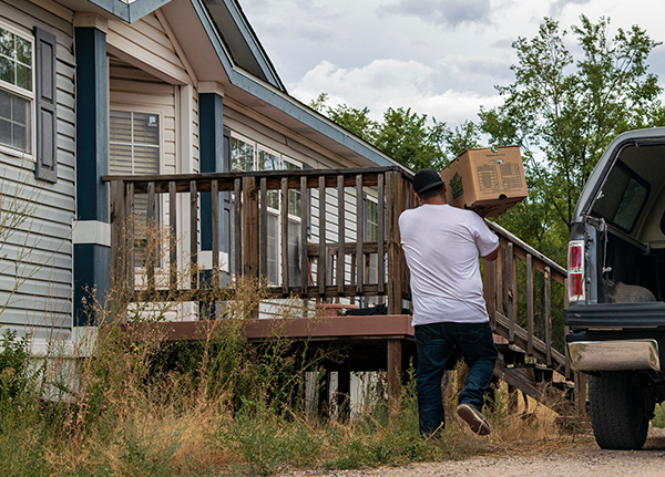 Man carrying a box into home-based business