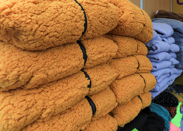 Stacks of fuzzy jackets for sale