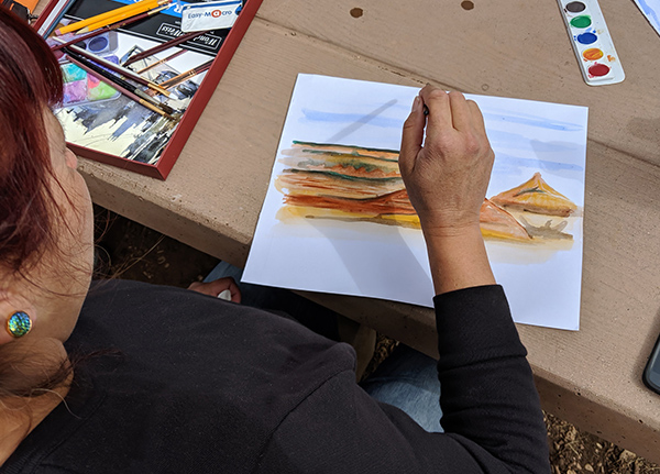 Woman working on watercolor painting