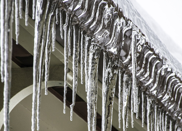 Gutters with icicles hanging over the edge