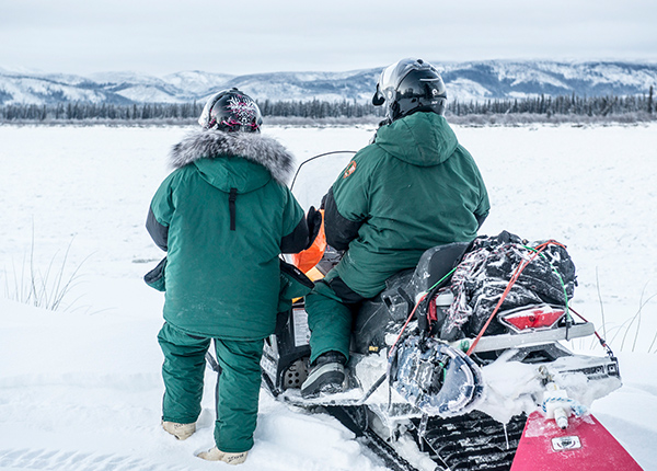 Two people snowmobiling