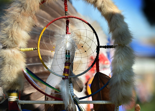 Dreamcatcher surrounded by beads, feathers, and fur