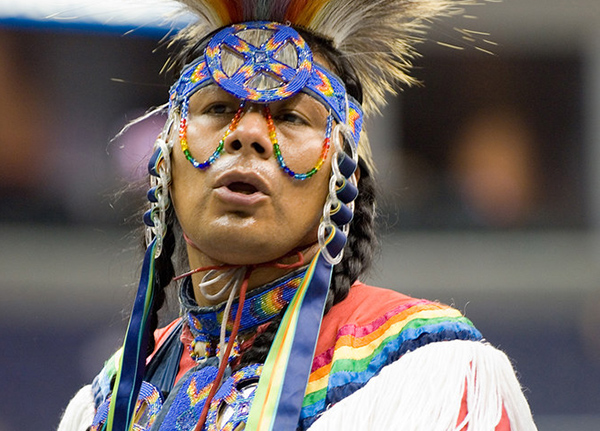 Man in traditional attire at a powwow