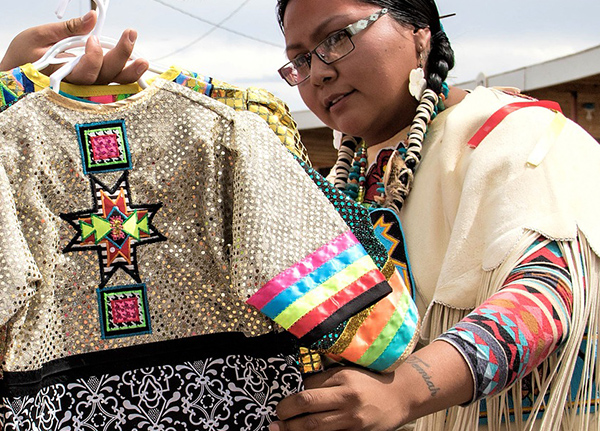 Woman looking at t-shirts with colorful tribal prints