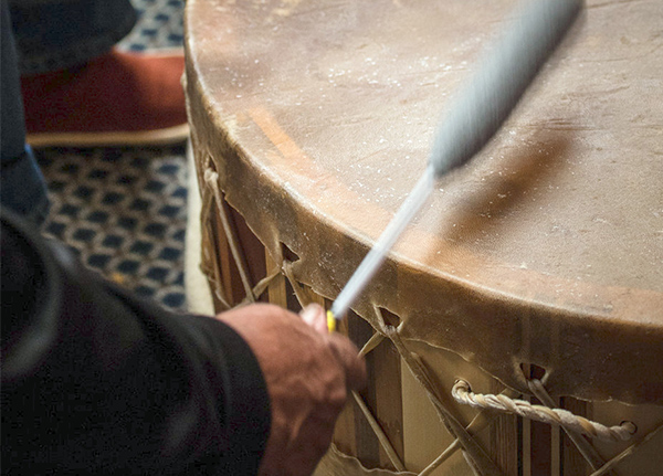 Person beating large drum