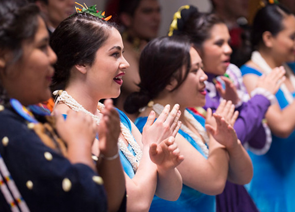 Women in traditional attire perform dance