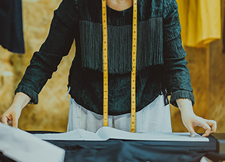 Seamstress looking at pattern on a table