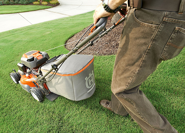 Person pushing lawn mower