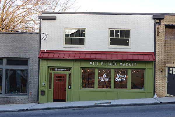 Storefront with Now Open painted on the window