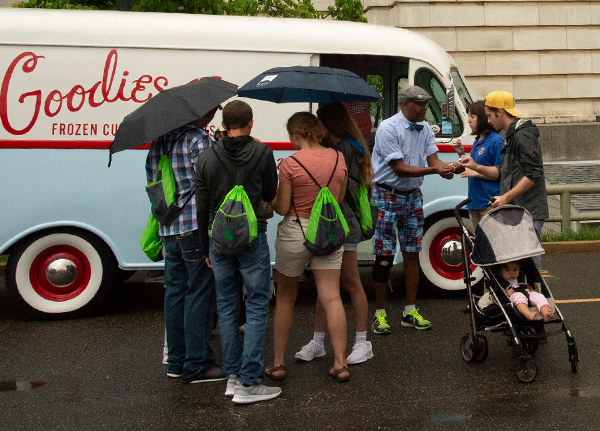 People buy products from a retro vehicle