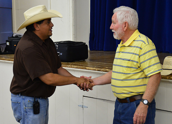 Two men shake hands