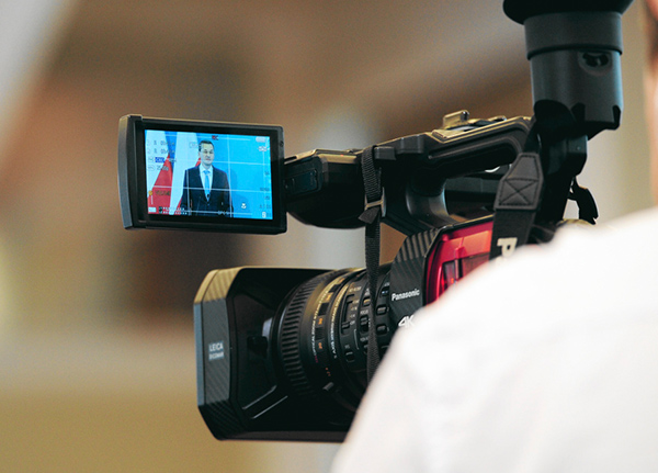 Video camera showing a person being filmed