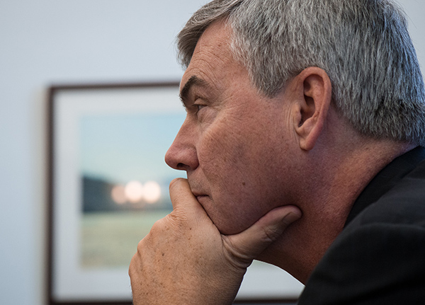 Profile of a man with his hand on his chin