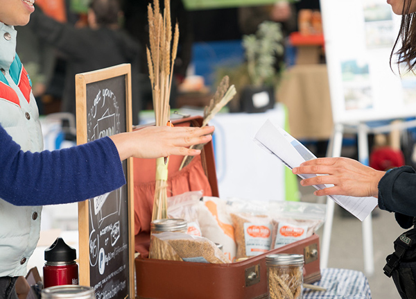 People exchanging goods at a farmer's market