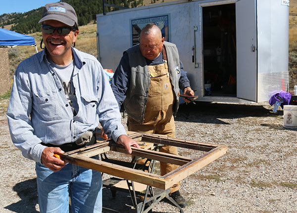 Two men work on an outdoor construction project