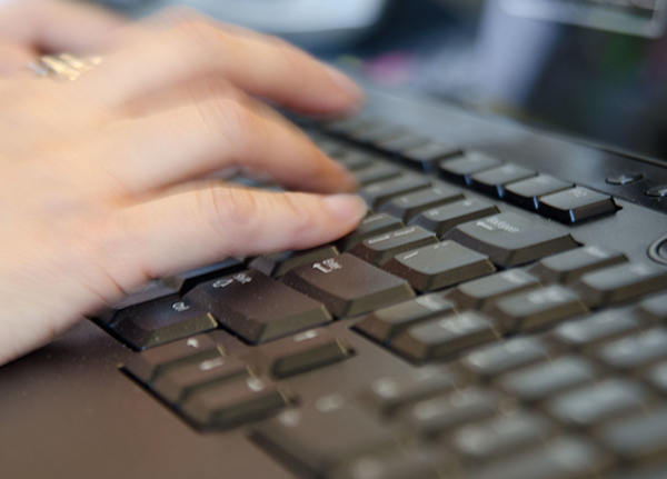 Hands typing on keyboard