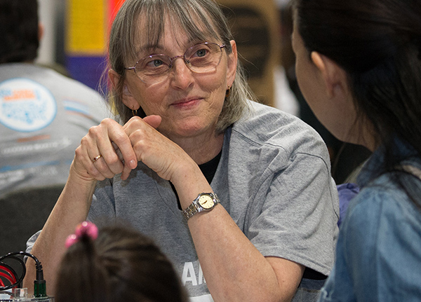 Woman smiles and listens to another person