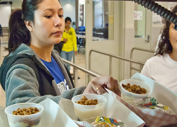 High schooler looks at school lunch