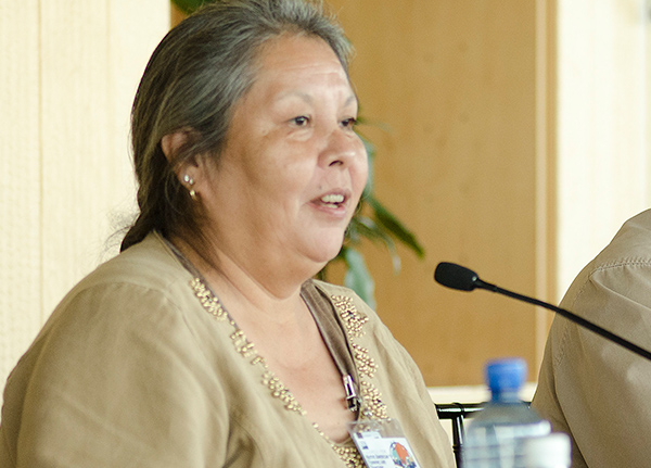 Woman speaking into a microphone