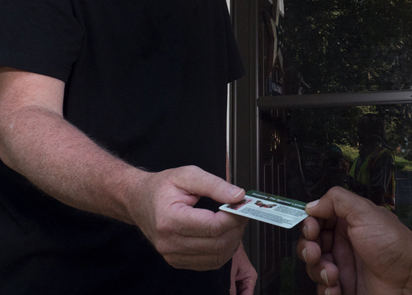 Two people exchanging a business card