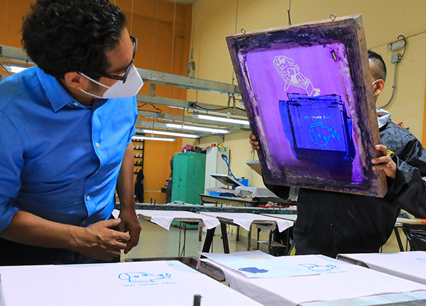 Two people in screenprinting shop