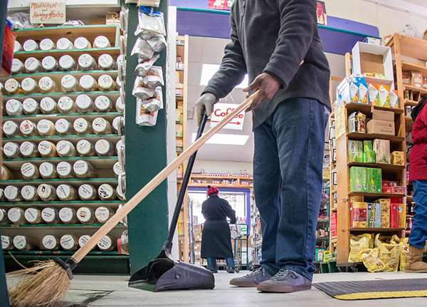 Person sweeps small grocery store