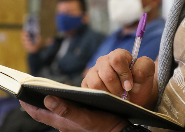 Person writing in notebook