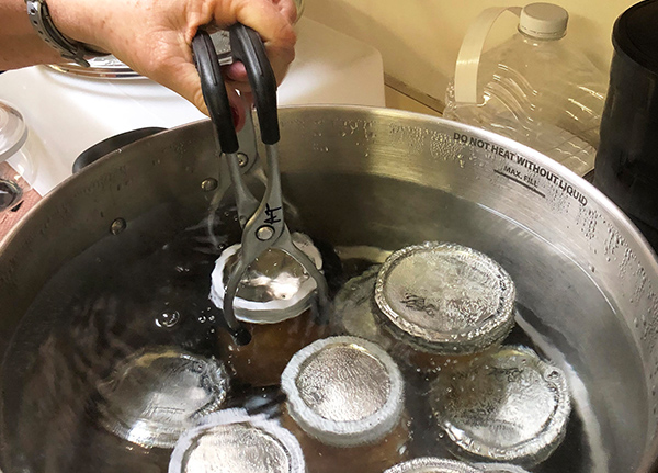 Person sealing preserve jars