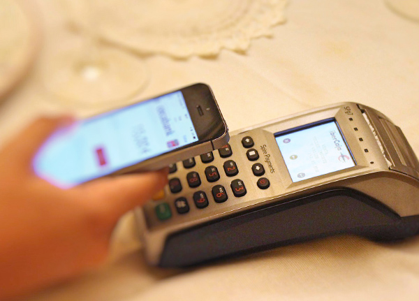 Phone being held next to point of sale machine